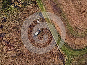 Old abandoned and rusty vehicles in the autumn field from above