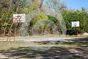 Old abandoned school sports court or schoolyard for basketball