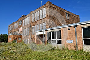 Old abandoned schoolhouse falling into ruins