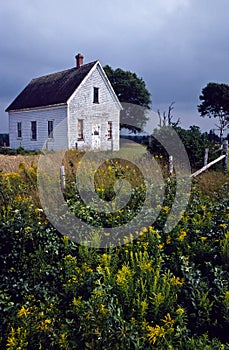 Old abandoned schoolhouse in a rural field