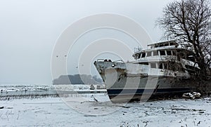 Old abandoned ship in frozen Danube river