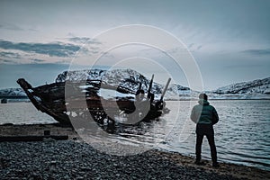 An old abandoned ship on the shore of the Barents Sea in the Arctic Ocean. The village of Teriberka Kola peninsula. The destroyed