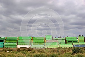 Old abandoned shipping containers stacked in an open field