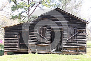 Old abandoned southern style farm barn sunny shadows