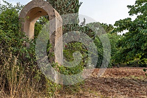 An old abandoned stone well in a state of ruin