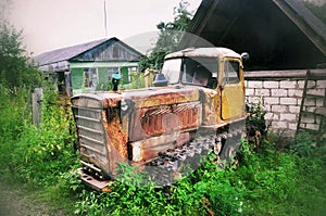 Old abandoned tracked tractor in russia