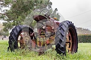 Old abandoned tractor sitting in the rain