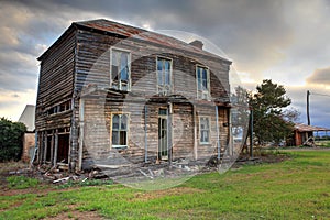 Old abandoned two storey wooden farmhouse photo