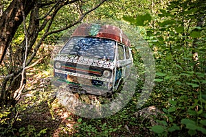 Old abandoned van in the thick of the forest