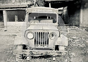 An old abandoned vehicle around a workshop