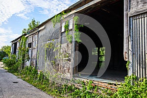 Old abandoned warehouse factory floor building, gaping hole in structure, truck port