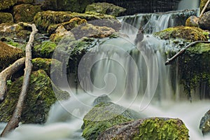 Old, abandoned water mill with water streams and little waterfalls