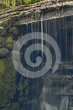 Old, abandoned water mill with water streams and little waterfalls