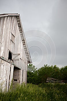 Old, Abandoned, Weathered Barn Door Swings in Stor