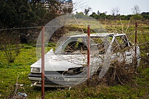 An old abandoned white car