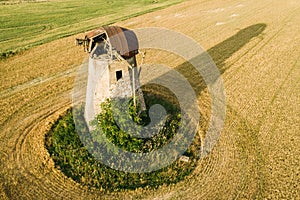 Old abandoned windmill in the wheat fields