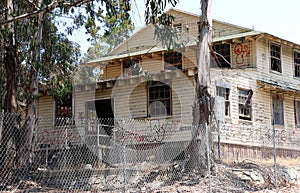 Old, abandoned wooden barracks, neglected and weathered..