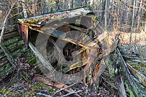 Old abandoned wooden fishing boat in the forest. Boat cemetery