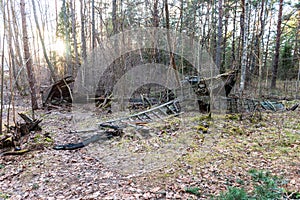 Old abandoned wooden fishing boat in the forest. Boat cemetery