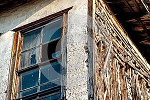 Old abandoned wooden house with broken glass, fragment