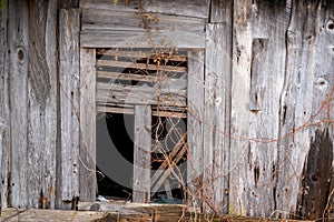 Old abandoned wooden house with broken window