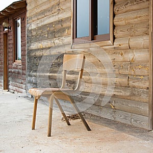 Old abandoned wooden house with chair outside