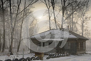 Old,abandoned wooden house in the village. Fog.