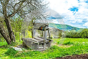 Old abandoned wooden well with beautiful structure on countryside.