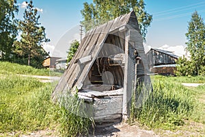 Old abandoned wooden well with beautiful structure in the Siberian village