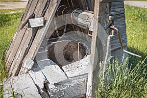 Old abandoned wooden well with beautiful structure in the Siberian village