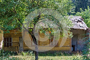 Old abandoned yellow wooden house