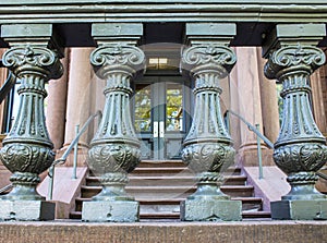 Old academic building detail - Silver painted balustrade with pink marble steps and entrance door visible showing through