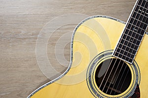 old acoustic guitar on wooden table background, music concept