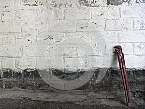 Old adjustable wrench standing at stone wall