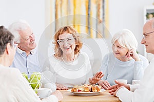 Happy seniors chatting at cafe photo