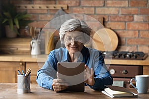 Old age grandmother enjoy reading e book on tablet pc