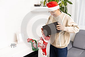 old age, holidays, problem and people concept - senior man in glasses thinking at home over christmas tree background