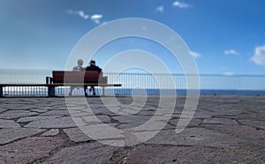 Old Age - Old couple sitting on a bench by the sea