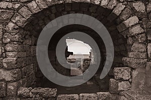 Old Aged Ach and brick wall. Grunge background. Bric. Stone Wall. Limestone. Rustic style. Monochrome