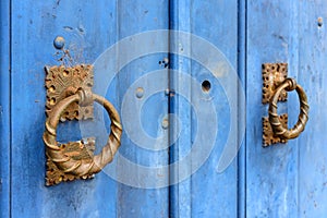 Old and aged blue historic church wooden door in the city of Sabara