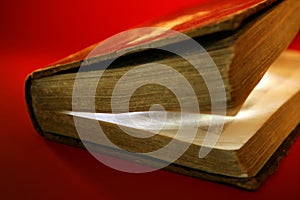 Old aged book close up, light glowing inside