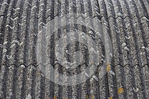 Old aged and damaged dangerous roof made of prefabricated and wave-shaped panels photo