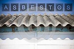 Old aged dangerous roof made of corrugated asbestos panels - one of the most dangerous materials in buildings and construction