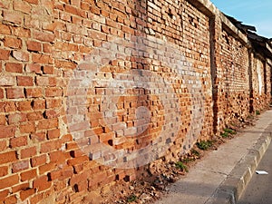 Old aged deteriorated brick wall construction