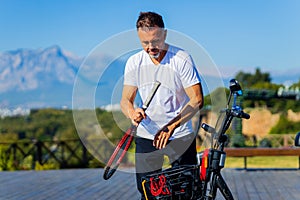 old-aged man good loking outdoors with eco scooter enjoying vacation