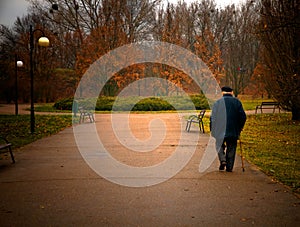 Old aged man walks in park