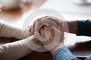 Old aged people holding hands close up view, support concept