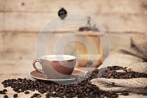 Old aged still life on coffee beans, cup and coffee grinder