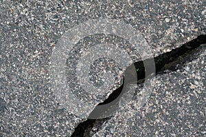 Old aged weathered cracked grey black tarmac texture pattern, large detailed damaged textured asphalt grungy background flat lay,