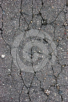 Old aged weathered cracked tarmac texture, large detailed damaged textured asphalt grungy background, vertical grey, black pattern